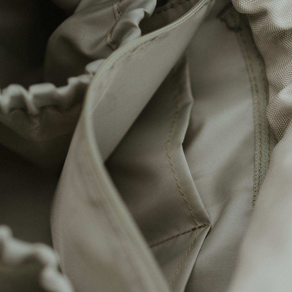 Close-up of a sage fabric texture with stitching details