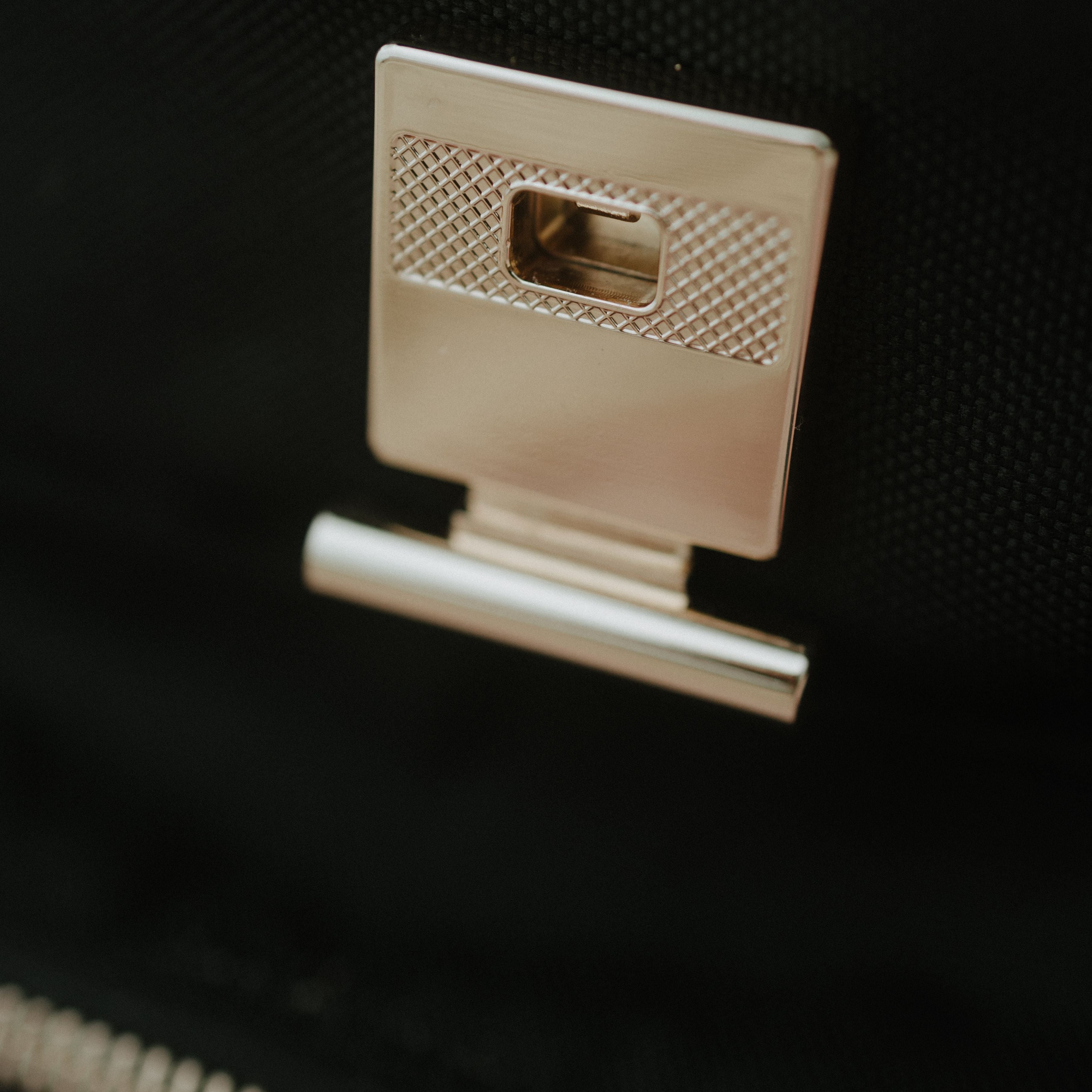 rose gold clip on black oversized backpack